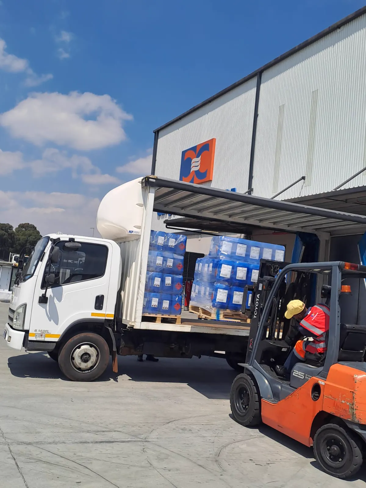 Forklift loading wrapped pallets onto an MDL Logistics truck from the side