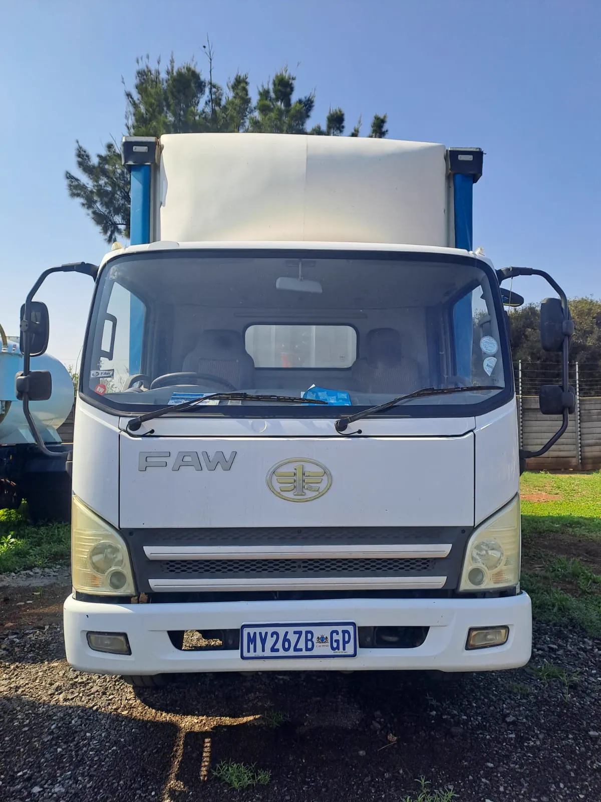 Front of the white FAW truck used by MDL Logistics